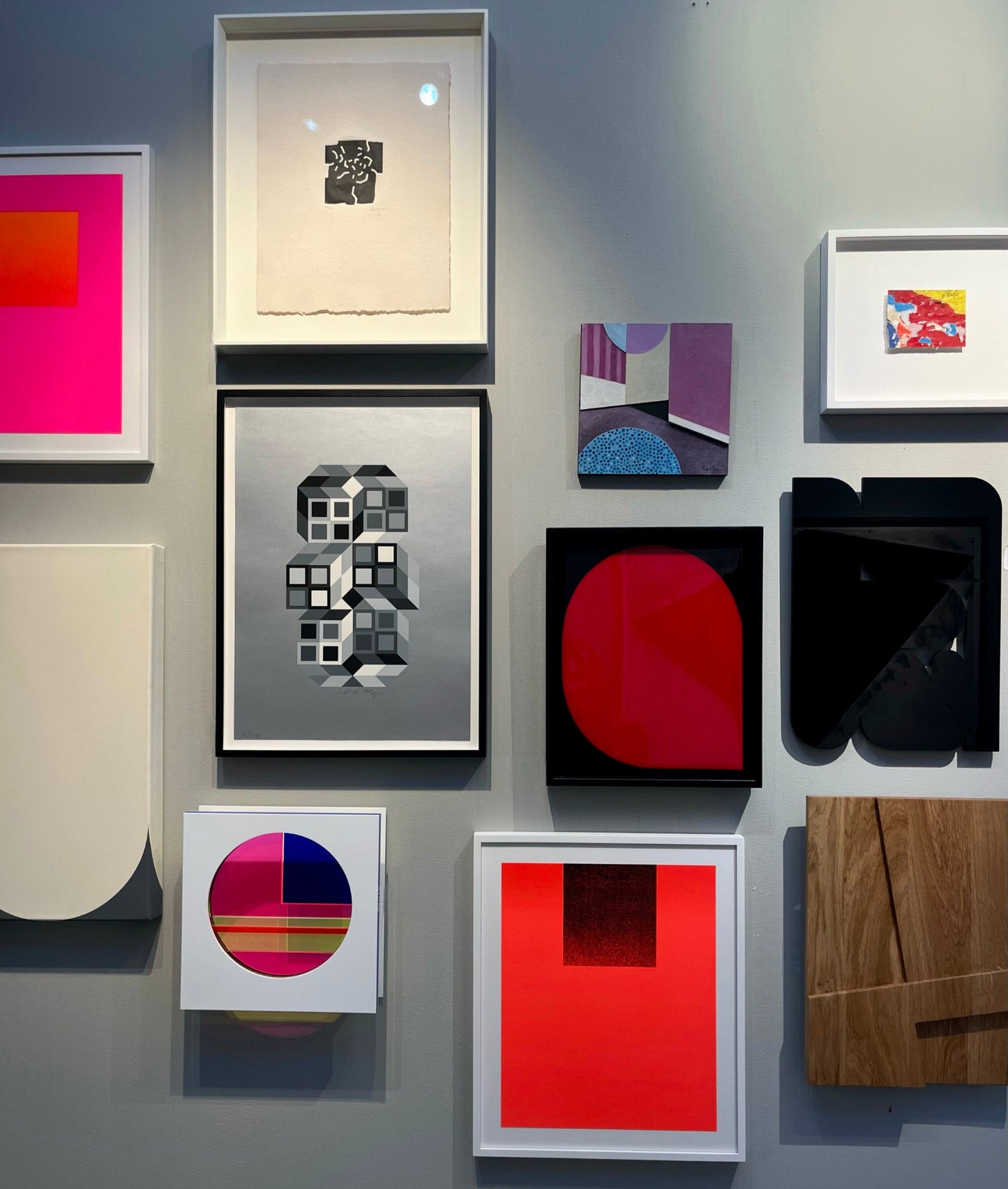 Composition Silver (1980) by Victor Vasarely – A screenprint surrounded by other geometric works by the artist, displayed on the wall. The silver tones in the piece complement the vibrant colors of the other works, collectively highlighting Vasarely's exploration of perception and visual harmony.