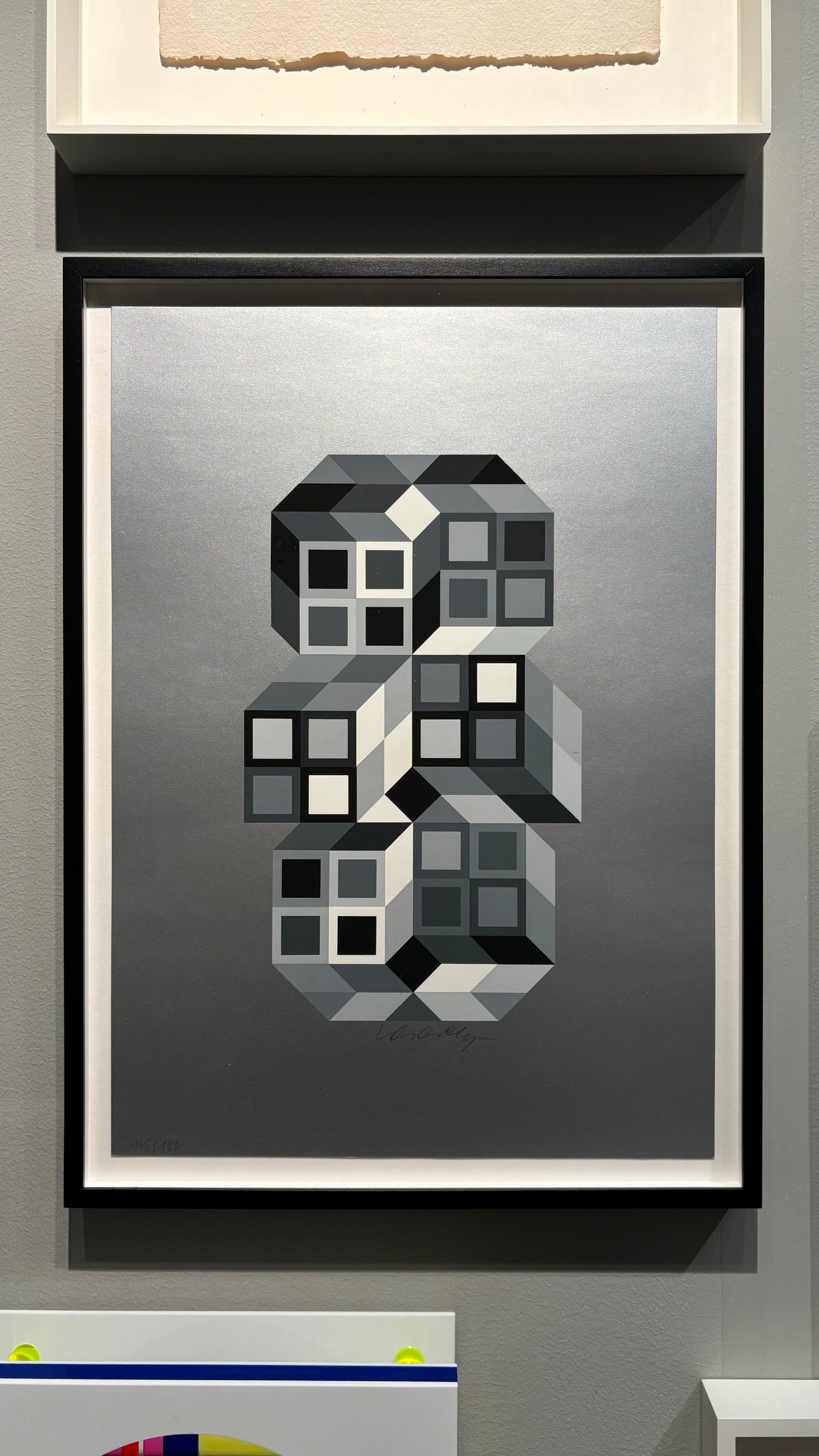 Composition Silver (1980) by Victor Vasarely – A framed screenprint, signed and numbered. The piece features dynamic, interlocking shapes in shades of silver, characteristic of Vasarely's Op Art style, creating an optical illusion that gives a sense of depth and movement.